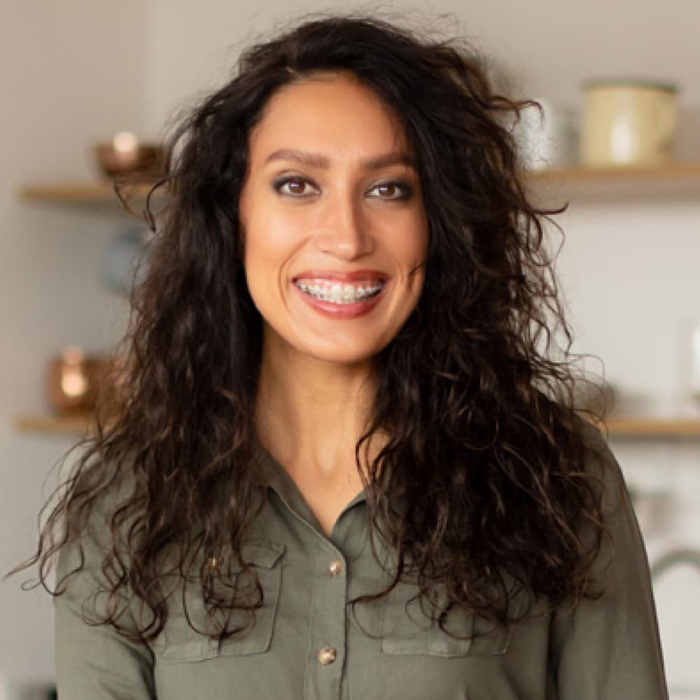 A smiling woman stands confidently